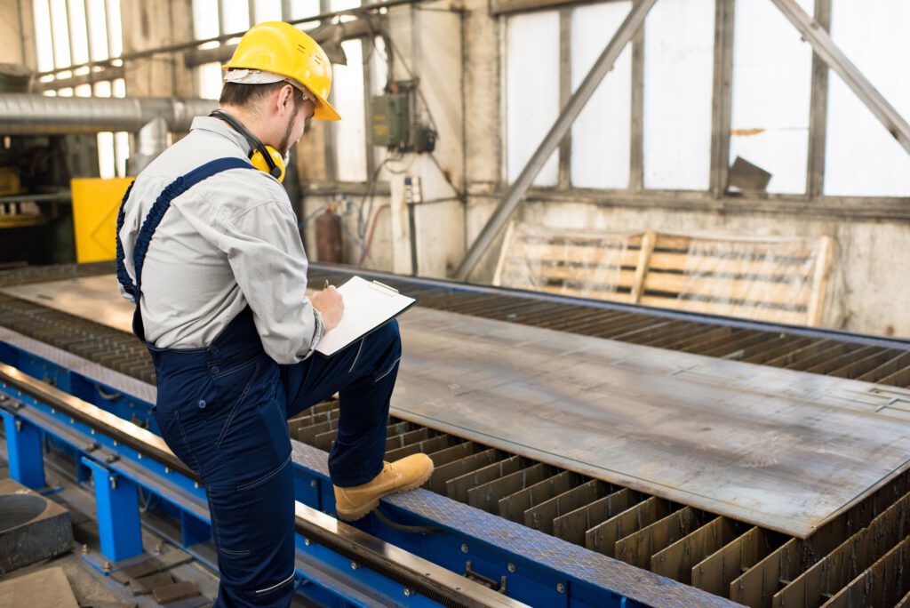 Engineer analyzing quality of metal sheet